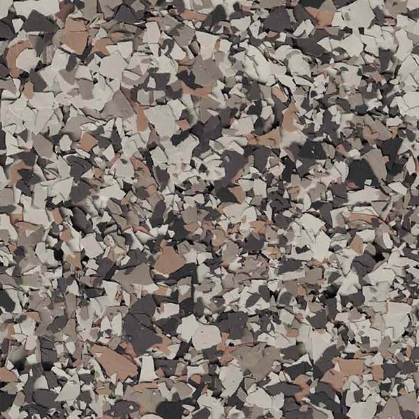 A textured surface with brown, black, and gray flecks, resembling a camouflage pattern or decorative stone flakes, creating an abstract, random design.