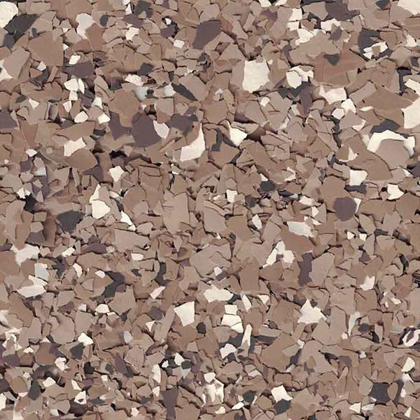 A close-up image of a textured surface with an irregular pattern of scattered brown, beige, and gray flakes, resembling a decorative design.