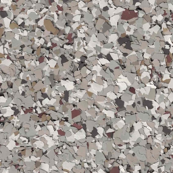 An abstract image featuring scattered, irregularly shaped pieces in various shades of gray, beige, and brown, creating a textured, mosaic-like pattern.