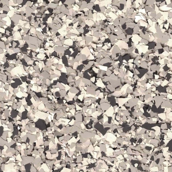 The image shows a close-up of a textured, multicolored speckled surface with a mix of black, gray, and white flakes.